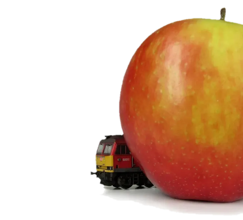 N gauge locomotive next to an apple — demonstrating the tiny scale of these models