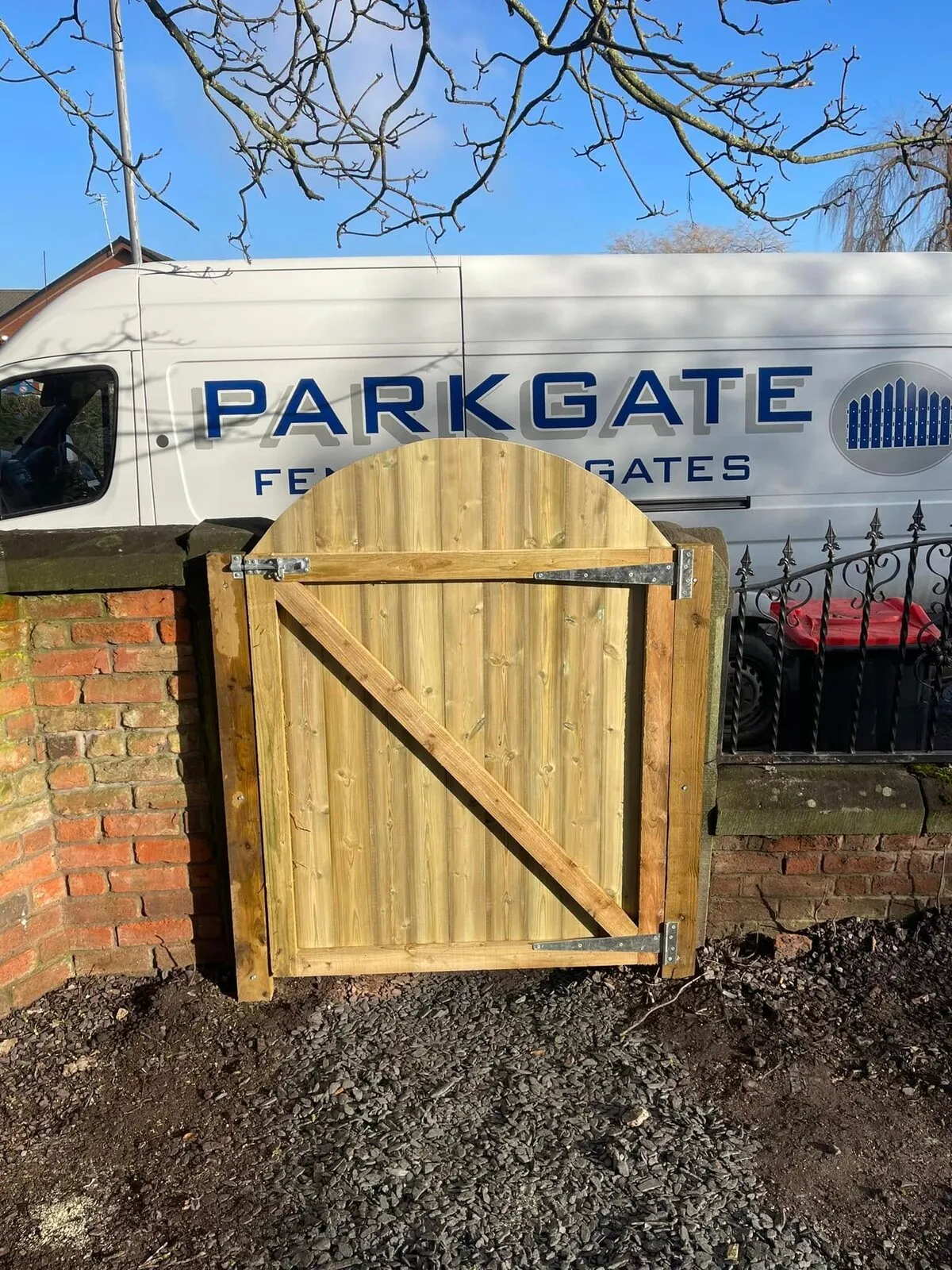 A wooden gate fitted by Parkgate, with their van behind it